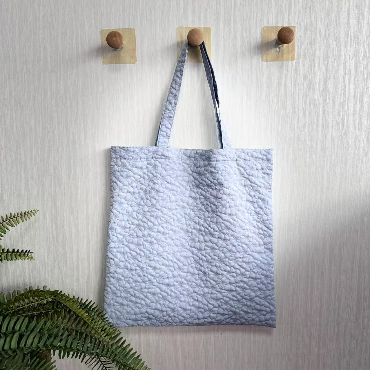 Embossed cloth handbag